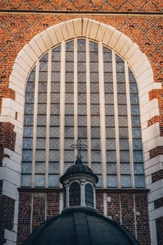 Window with mosaic and arch of Corpus Christi Basilica, beautiful details of Gothic church and landmark in Krakow, Poland