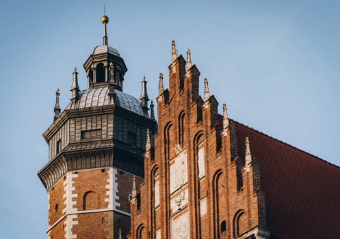 Dome with cross, roof and Gothic facade of Corpus Christi Basilica, historical religious landmark in Krakow, Poland