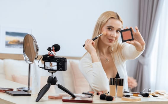 Young woman making beauty and cosmetic tutorial video content for social media. Beauty blogger smiles to camera while showing how to beauty care to audience or followers. Panorama Blithe