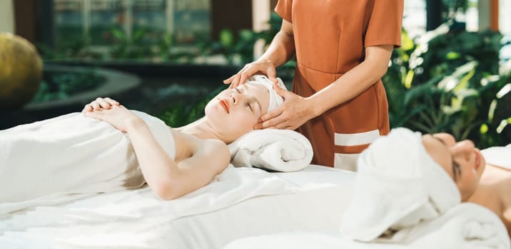 A portrait of two caucasian woman with beautiful skin having facial massage while falling the deep state of relaxation surrounded by outdoor natural and peaceful environment. Tranquility.