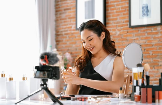 Woman influencer shoot live streaming vlog video review makeup uttermost social media or blog. Happy young girl with cosmetics studio lighting for marketing recording session broadcasting online.