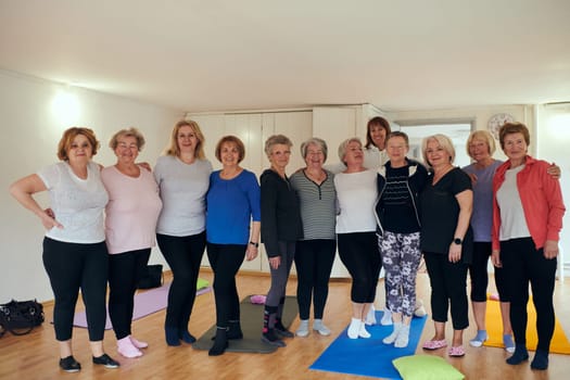 A vibrant community of senior women, guided by their instructor, embraces the enriching journey of yoga, fostering unity, well-being, and a shared commitment to active aging.