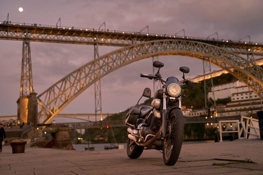 Old bike on background of the Dom Luis I Bridge in Porto, Portugal