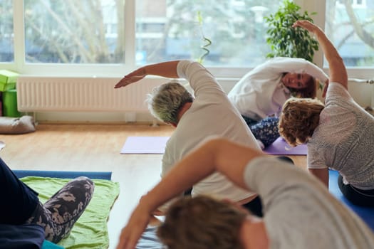 A group of senior women engage in various yoga exercises, including neck, back, and leg stretches, under the guidance of a trainer in a sunlit space, promoting well-being and harmony.