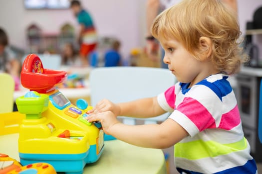 Child playing with colorful toys at the learning center or in kindergarten.