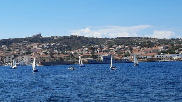 yachts are moored near the sea against the backdrop of mountains in the haze. High quality photo