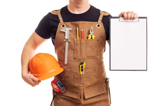 Male worker or builder in apron with helmet holding a clipboard isolated on white background