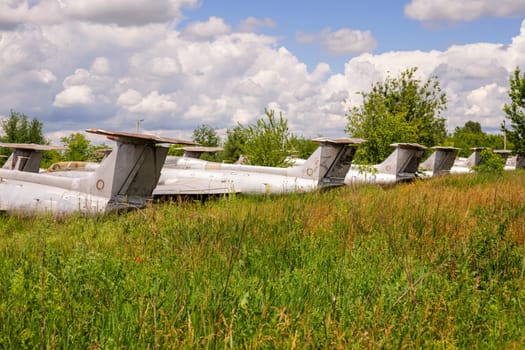 Old abandoned airfield with abandoned planes. Abandoned rusty old planes on the grass
