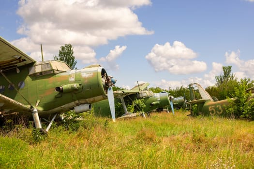 Old abandoned airfield with abandoned planes. Abandoned rusty old planes on the grass