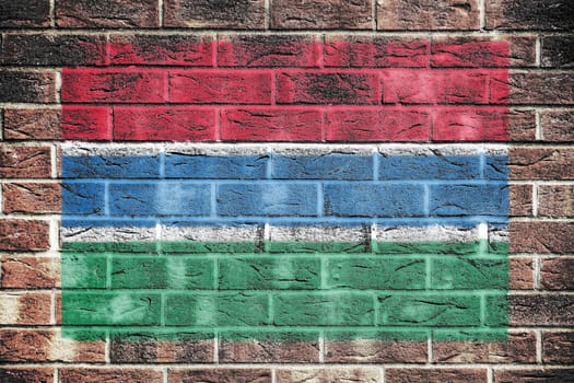 A Gambia flag painted on brick wall background