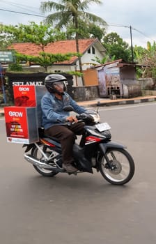 motorbike riding in asia as one of goods transportation method, being used to transport many kind of goods intercity in central java indonesia