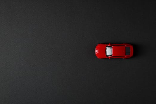 top view of toy red car on dark background