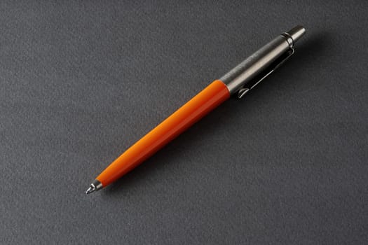 Close up of a vintage style Ballpoint pen on a dark gray background