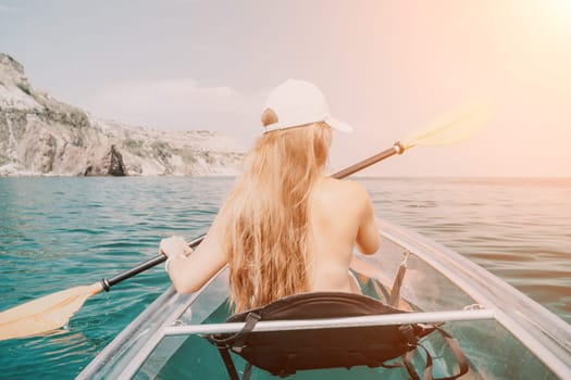 Woman in kayak back view. Happy young woman with long hair floating in transparent kayak on the crystal clear sea. Summer holiday vacation and cheerful female people having fun on the boat.