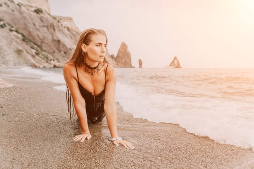 Woman travel sea. Young Happy woman in a long red dress posing on a beach near the sea on background of volcanic rocks, like in Iceland, sharing travel adventure journey