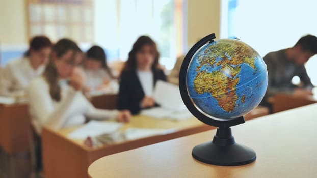 A globe of the world in a school classroom during a lesson