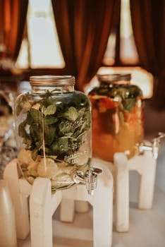 Catering. Drinks on wedding party. Cocktail glasses full of red alcohol stand on table. Beautiful row line of different colored alcohol cocktails with mint on a open air party, martini, vodka fresh