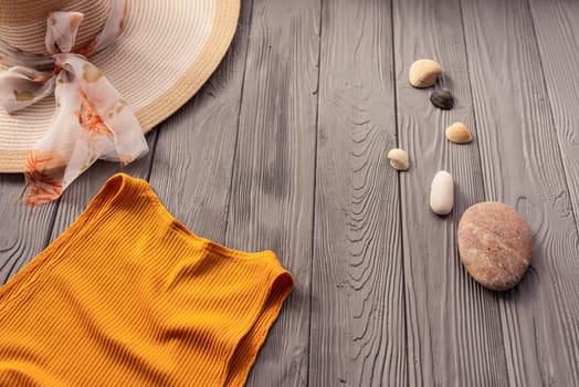 beachwear orange woman top outfit hat bag sun protection sunglasses pebbles. Summer background template mockup free space composition sample text. Top view above wooden background vacation concept