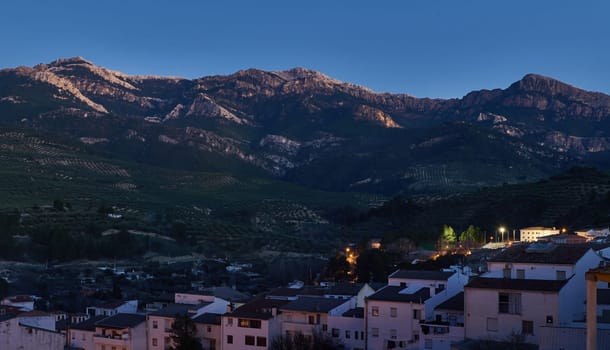 Sierra de Cazorla. Quesada Andalusia Spain. Aerial view of beautiful mountains at evening after sunset and white buildings on the foreground. Tourism. Discovering medieval and historic Spanish cities