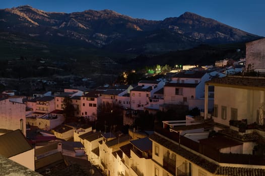 Quesada by night - beautiful medieval and historic city in province of Jaen in Andalusia, Spain. Tourism and Travel concept. White buildings and houses illuminated by street lighting in the night time
