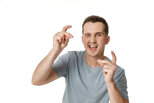 portrait of young happy man winking looking at the camera on white background