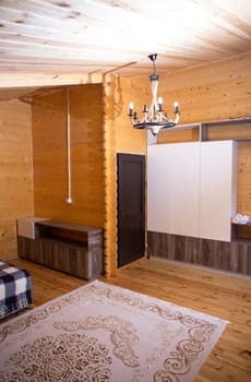 Cozy studio with warm wood paneling, fully equipped kitchen, comfortable bed, and private bathroom. Perfect for a relaxing stay.