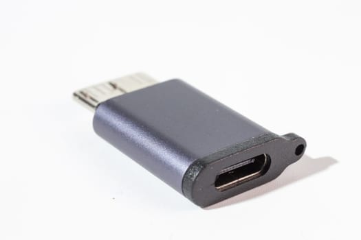 This high-quality image displays a black Type-C to Micro-USB adapter. The adapter is elegantly isolated on a clean white background.