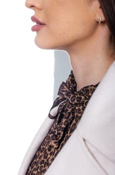 A stylish young woman with long dark hair, wearing a white blazer over a leopard print blouse with a chic bow detail.