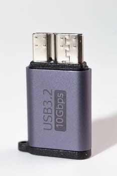 The image shows a dark grey USB 3.2 flash drive with a Type-C connector. The drive is isolated on a white background.