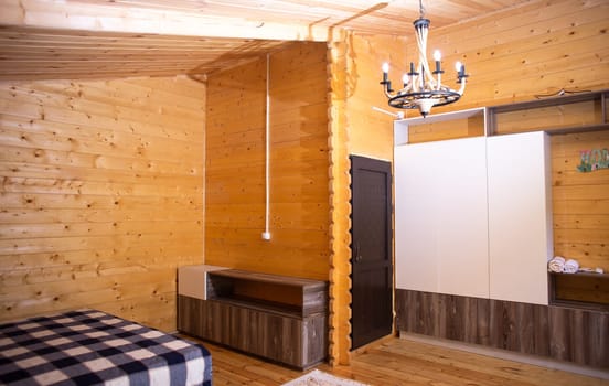 Cozy studio with warm wood paneling, fully equipped kitchen, comfortable bed, and private bathroom. Perfect for a relaxing stay.