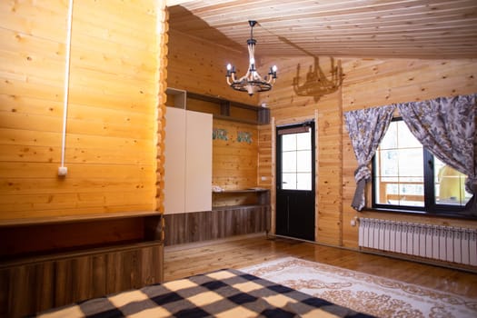 Cozy studio with warm wood paneling, fully equipped kitchen, comfortable bed, and private bathroom. Perfect for a relaxing stay.