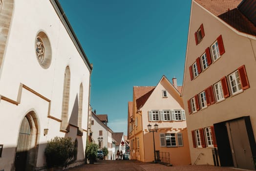 Old national German town house. Old Town is full of colorful and well preserved buildings. Baden-Wurttemberg is a state in southwest Germany bordering France and Switzerland. The Black Forest, known for its evergreen scenery and traditional villages, lies in the mountainous southwest. Stuttgart, the capital, is home to Wilhelma, a royal estate turned zoo and gardens. Porsche and Mercedes-Benz have headquarters and museums there. The 19th-century Hohenzollern Castle sits in the Swabian Alps to the south.