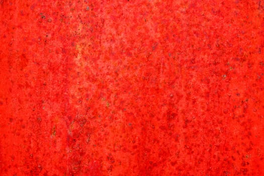 Red metal and paint creating textured wall background