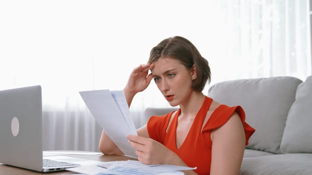 Stressed young woman has financial problems with credit card debt to pay prim from bad personal money and mortgage pay management crisis. Woman worry about financial bankruptcy risk from over spending