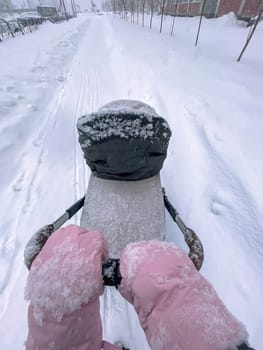 Father leading the way during a serene winter walk, blanketed in freshly fallen snow. Vertical photo