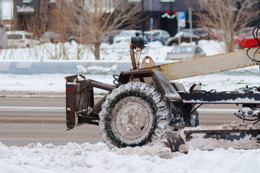 Snow plow is parked on the side of the road, its powerful the winter landscape.