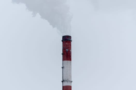Plume of Steam Rising From Thermal Plant Pipe Against Grey Sky. Copy space