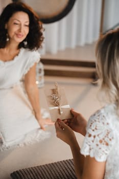 A woman in white clothes holds an envelope with a wish in her hands. The concept of a women's circle.