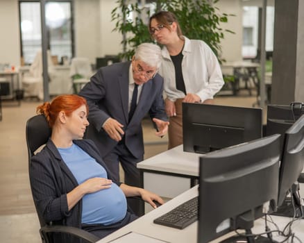 A pregnant woman sleeps at her workplace. Colleagues are indignant