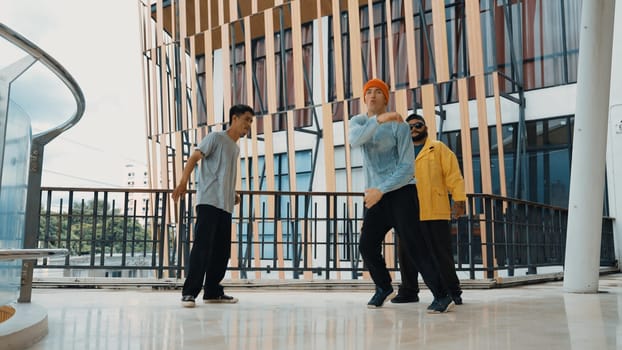 Hip hop team dance break dance while multicultural friend surrounded and clapping hands to cheer or encourage his friend to dance. Active and energetic street dance. Outdoor sport 2024. Endeavor.