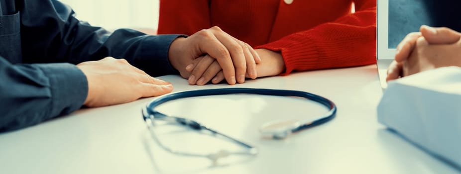 Couple attend fertility or medical consultation with gynecologist at hospital as family planning care for pregnancy. Husband and wife consoling each other through doctor appointment. Panorama Rigid