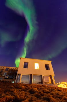 Northern lights over a hotel in Stykkisholmur, Iceland