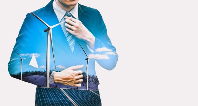 Double exposure graphic of business people working over wind turbine farm and green renewable energy worker interface. Concept of sustainability development by alternative energy. uds