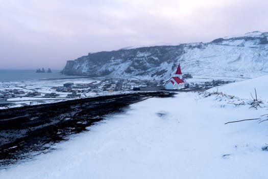 View of the Icelandic town of Vik after a snowfall at sunset