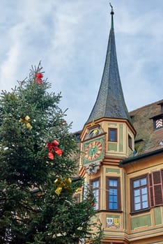 Winter Festivities in Bitigheim-Bissingen: Charming Half-Timbered Houses Adorned with Christmas Decorations. Step into the enchanting New Year's atmosphere of Bitigheim-Bissingen, Baden-Württemberg, Germany, where half-timbered houses line the streets, beautifully decorated with festive Christmas ornaments. The photograph is artfully processed in warm vintage tones, capturing the essence of winter joy in this picturesque town.