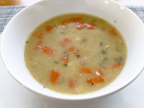 comforting bowl of chicken and rice soup, brimming with tender carrots and seasoned to perfection, promises warmth and satisfaction.