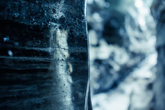 Icelandic glacier ice blocks in crevasse, frozen wintry landscapes with transparent rocks inside ice caves. Water dripping from cracked texture caverns of ice in iceland, vatnajokull.