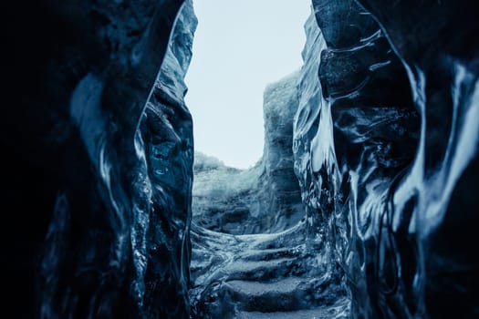 Big ice rocks inside glacier crevasse, transparent vatnajokull ice caves in icelandic landscapes. Spectacular frozen icebergs on wintry polar weather, melting icy blocks with cracked structure.