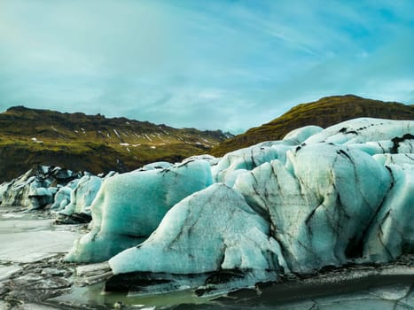 Aerial view of vatnajokull glacier mass, fantastic blue glacier lagoon forming on frozen lake in icelandic region. Spectacular nordic icebergs and glacial ice blocks cracked on icy land.