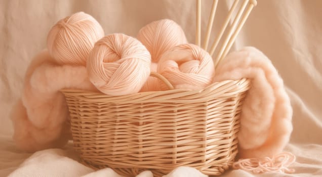 A basket of yarn balls and knitting needles with a soft knitted fabric in warm tones. High quality photo